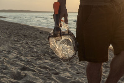 Low section of people standing on beach