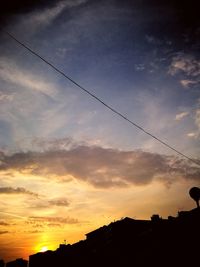 Low angle view of silhouette buildings against sky during sunset