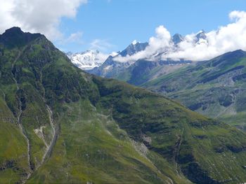 Scenic view of mountains against cloudy sky