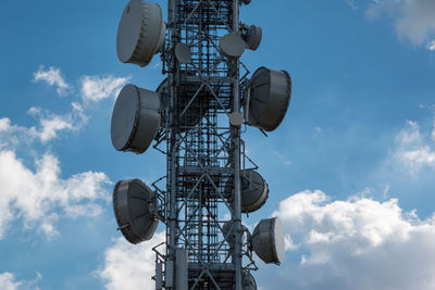 Low angle view of communications tower against sky