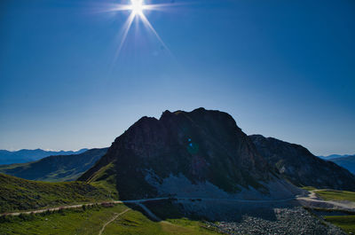 Scenic view of mountains against clear blue sky