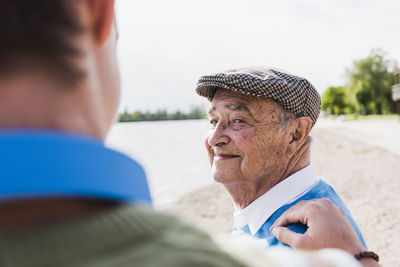 Portrait of smiling senior man looking at his grandson