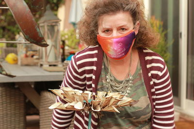 Portrait of woman wearing mask outdoors
