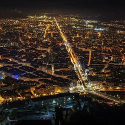 High angle view of city lit up at night