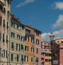 Low angle view of buildings in town against sky