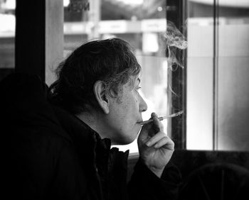 Portrait of man smoking cigarette