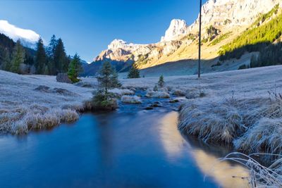 Scenic view of lake against sky during winter