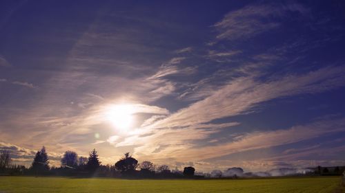 Scenic view of field against sky during sunset