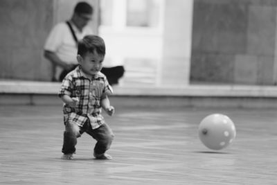 Full length of a boy playing with ball