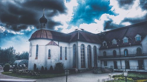 Facade of building against cloudy sky