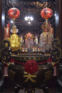 Illuminated lanterns hanging in building