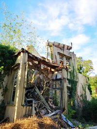 Low angle view of abandoned building against sky