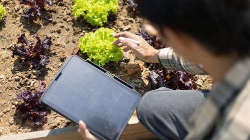 Midsection of woman using digital tablet