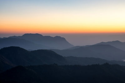 Scenic view of silhouette mountains against sky during sunset