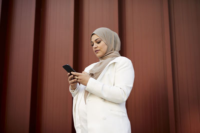 Smiling woman using cell phone