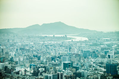 Aerial view of cityscape against clear sky