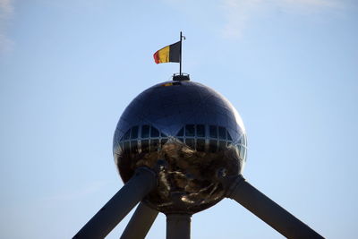 Low angle view of flags against clear sky