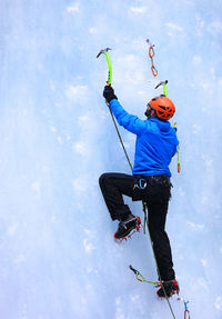 Side view of man ice climbing