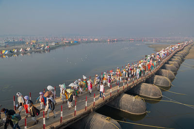 Crowd over river on footbridge