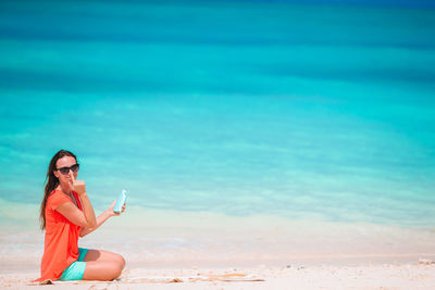 Woman sitting on beach