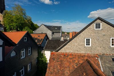 Houses and buildings in town against sky