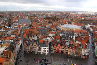 High angle view of river amidst buildings against sky