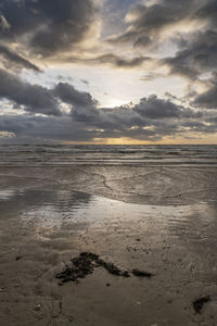 Scenic view of beach against sky during sunset