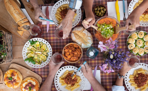 Cropped hands of people having food on table