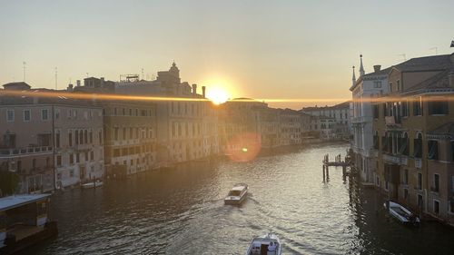 View of buildings at waterfront during sunset