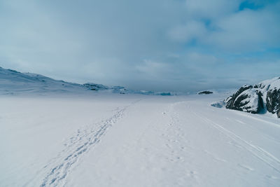 Scenic view of snow covered mountains against sky