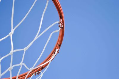 Low angle view of basketball hoop against clear blue sky