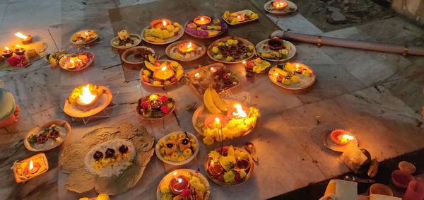 High angle view of lit candles on table