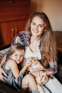 Portrait of happy girl sitting on floor