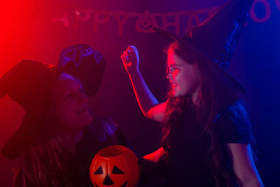 Young woman enjoying music concert at night