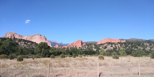 Scenic view of mountains against clear blue sky