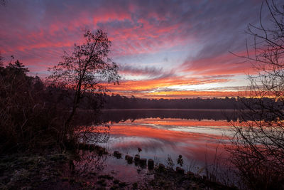 Scenic view of lake against romantic sky at sunset