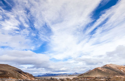 Low angle view of mountain against cloudy sky