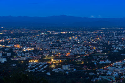 High angle view of illuminated city against sky at night