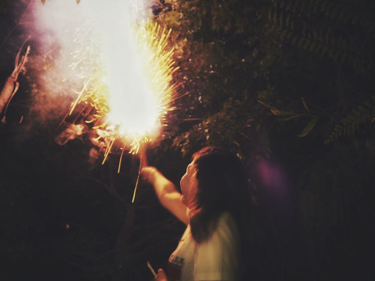 event, celebration, real people, motion, sparkler, glowing, blurred motion, illuminated, women, burning, firework, arts culture and entertainment, heat - temperature, firework - man made object, night, firework display, people, holding, leisure activity, long exposure, sparks, outdoors