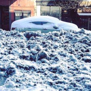 Snow covered houses in city