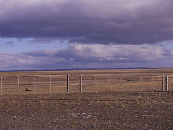 Fence on field against sky, pampas argentina 