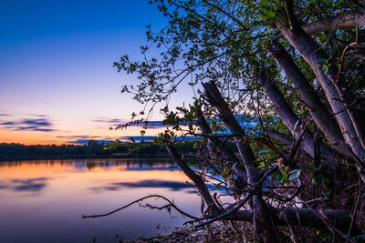 Scenic view of lake against sky at sunset