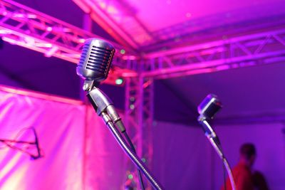 Close-up of microphone on stage at music concert