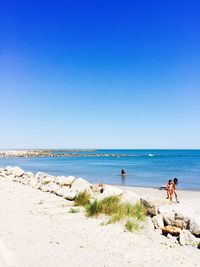 Scenic view of beach against blue sky