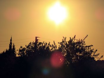Silhouette trees against sky during sunset