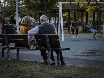 People sitting on walkway in park