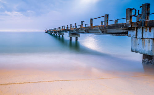 Pier over sea against sky