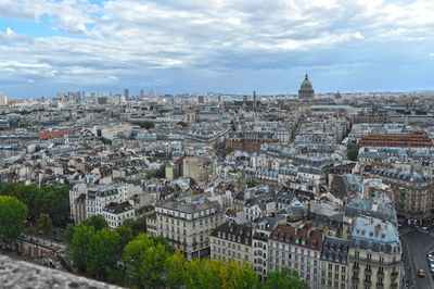 High angle view of buildings against cloudy sky