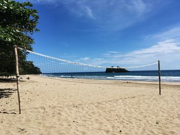 Scenic view of beach against blue sky