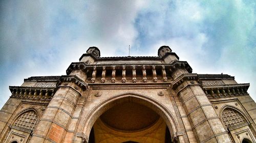 Low angle view of historical building against cloudy sky